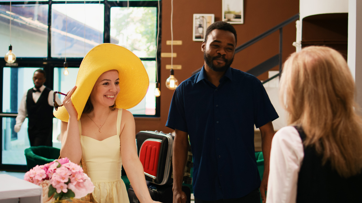 Hotel employee greeting guests